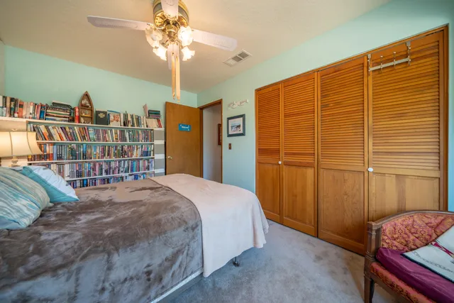 a view of a house with a yard and wooden fence
