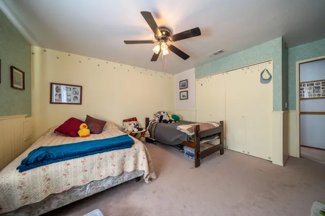 a view of a patio with table and chairs and potted plants with large tree