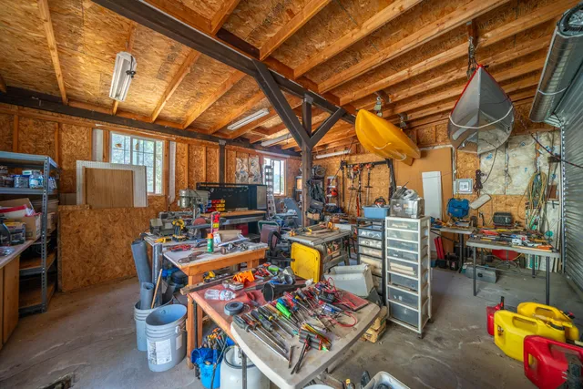 a view of backyard with swimming pool and seating space
