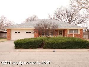 6711 Elmhurst Road Amarillo, TX 79106 - Photo 1 of 15 a view of a white house next to a yard with potted plants