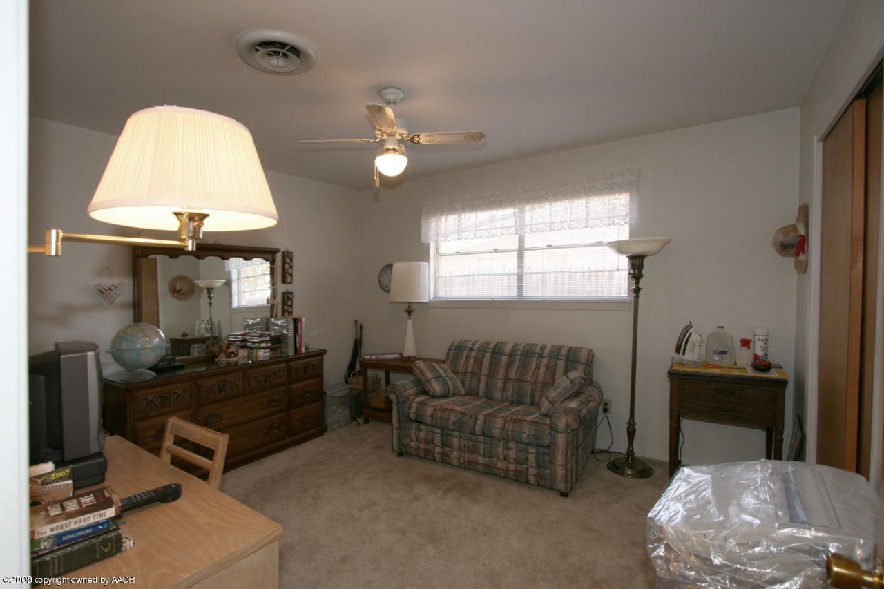 6711 Elmhurst Road Amarillo, TX 79106 - Photo 3 of 15 a living room with furniture and a chandelier