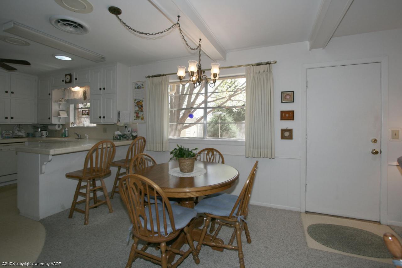 6711 Elmhurst Road Amarillo, TX 79106 - Photo 5 of 15 a dining room with furniture and window