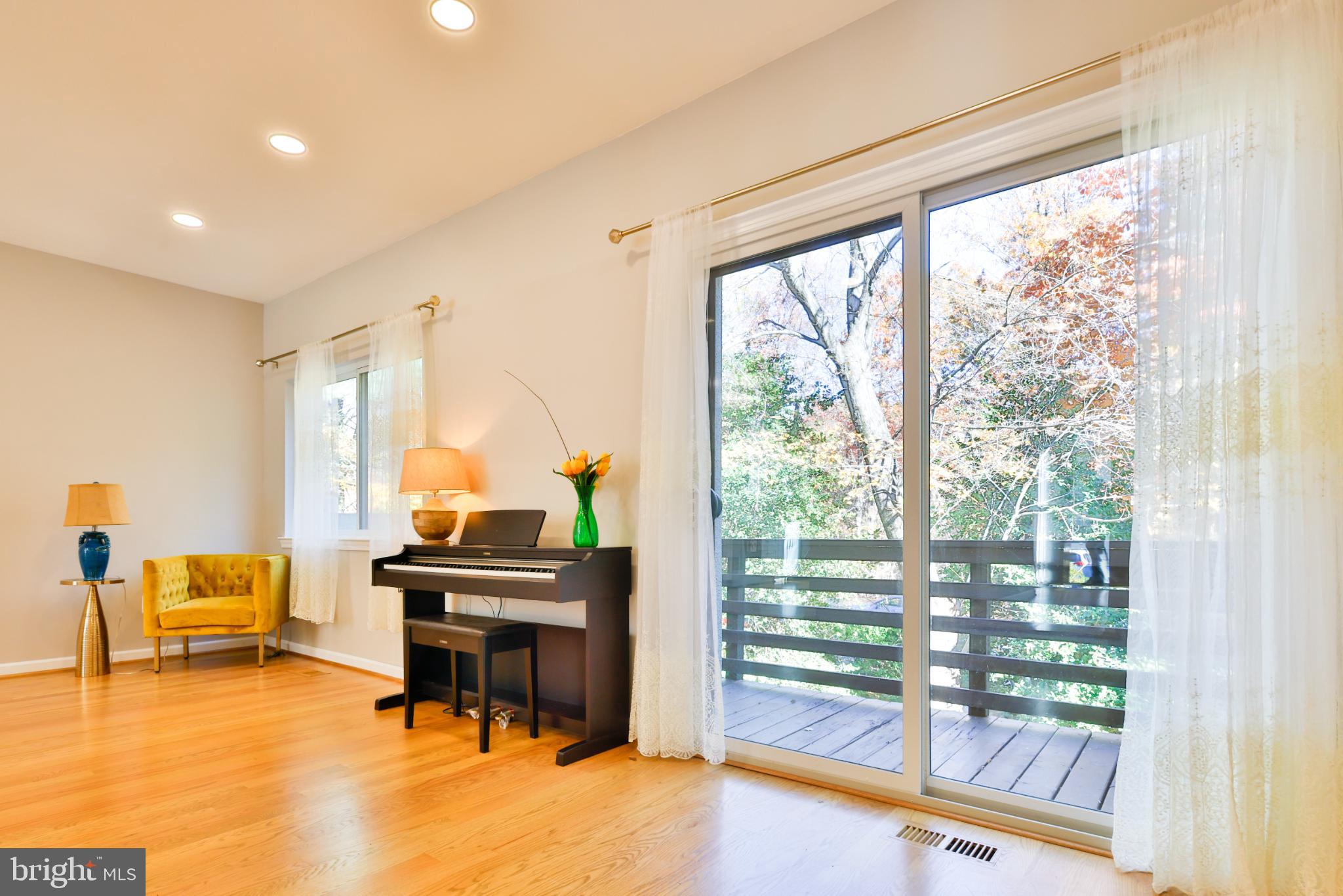11817 Coopers Court Reston, VA 20191 - Photo 11 of 58 a living room with furniture and a floor to ceiling window