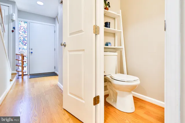 a view of entryway and hall with wooden floor