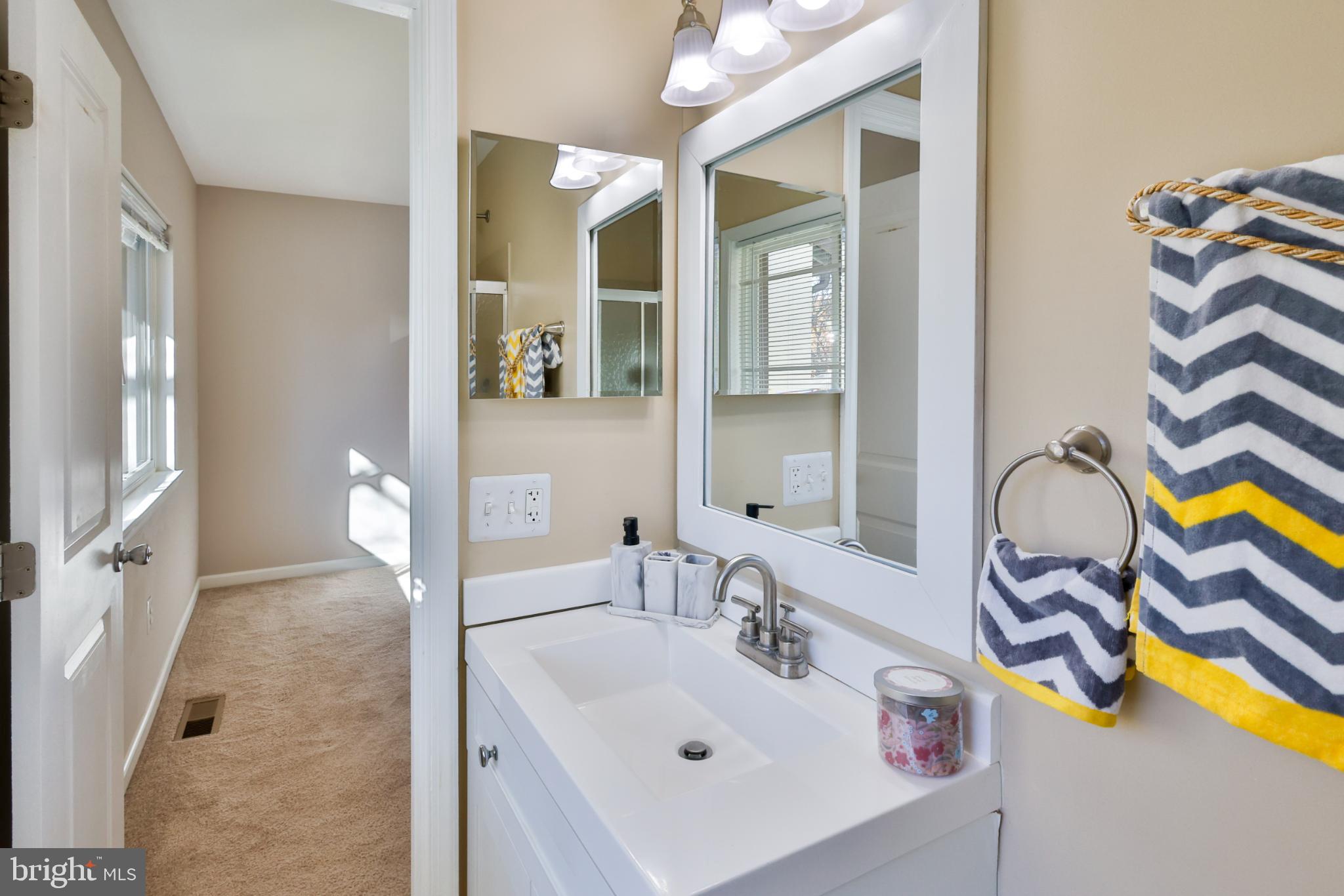 11817 Coopers Court Reston, VA 20191 - Photo 22 of 58 a bathroom with a sink mirror and vanity