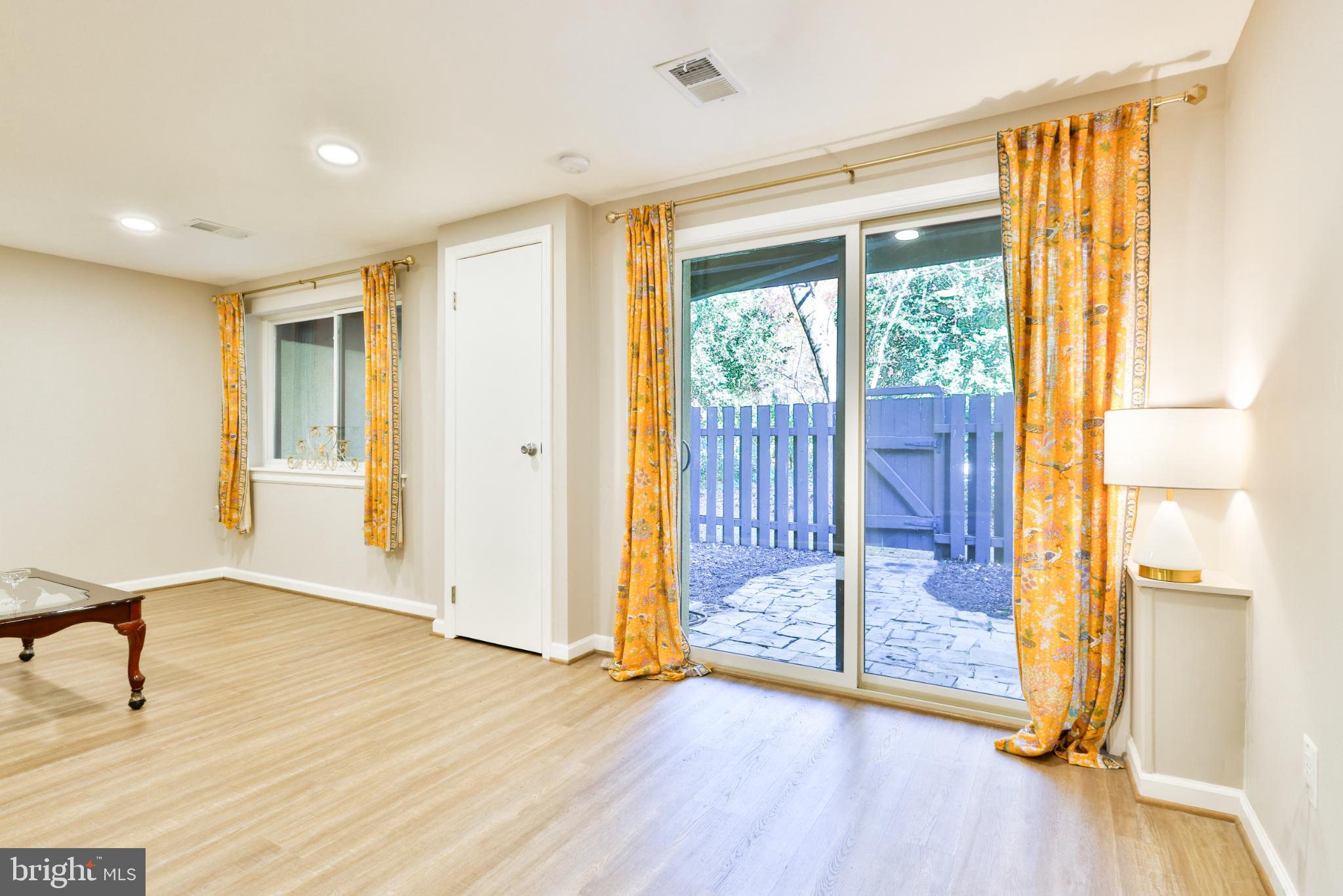 11817 Coopers Court Reston, VA 20191 - Photo 39 of 58 a view of empty room with wooden floor and windows