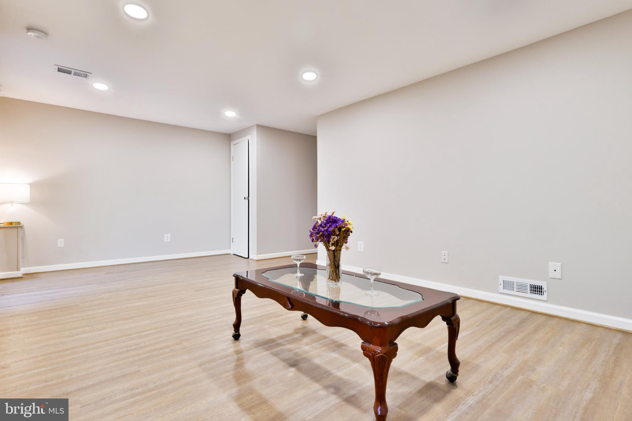 11817 Coopers Court Reston, VA 20191 - Photo 42 of 58 a room with furniture and wooden floor