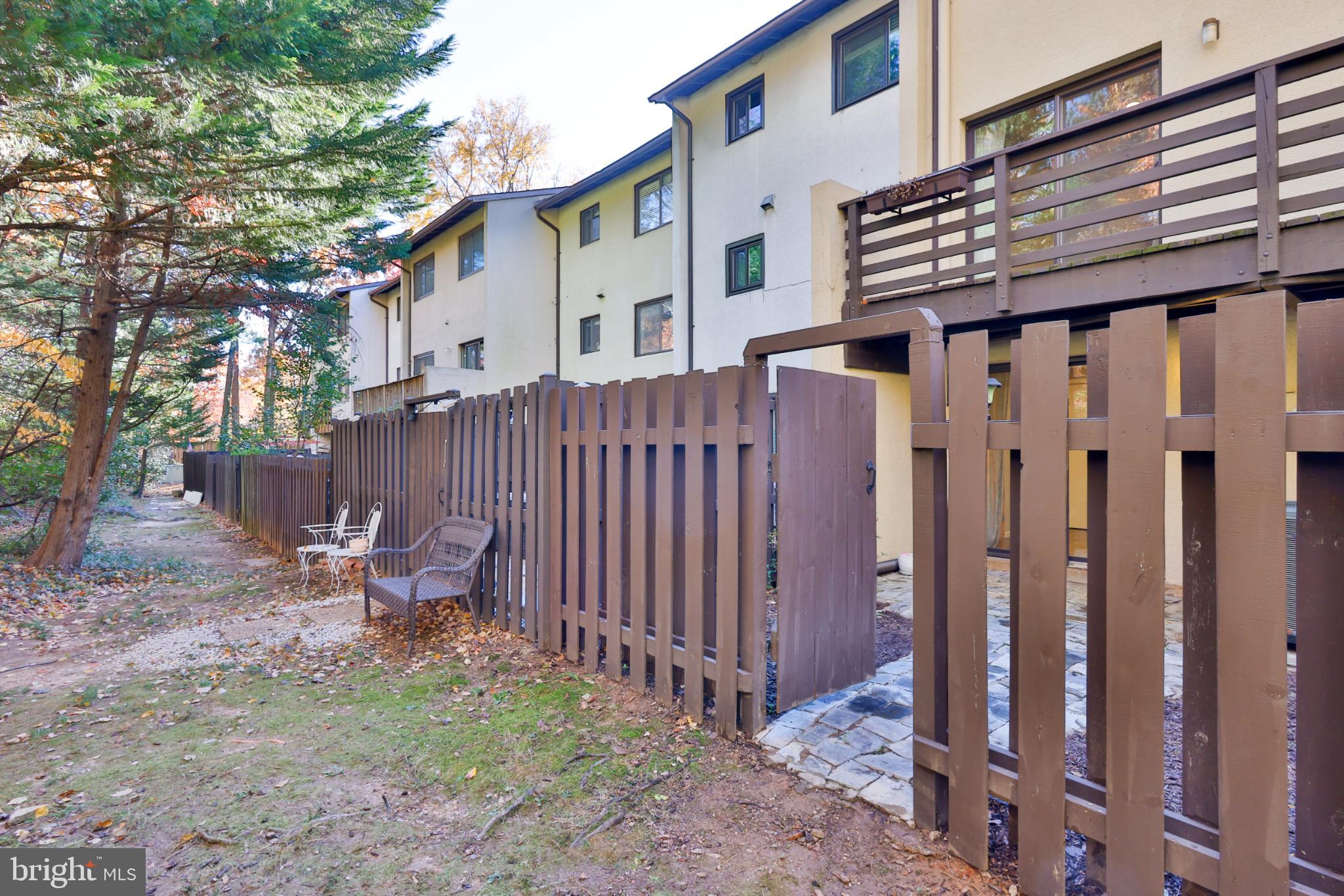 11817 Coopers Court Reston, VA 20191 - Photo 50 of 58 a backyard of a house with table and chairs