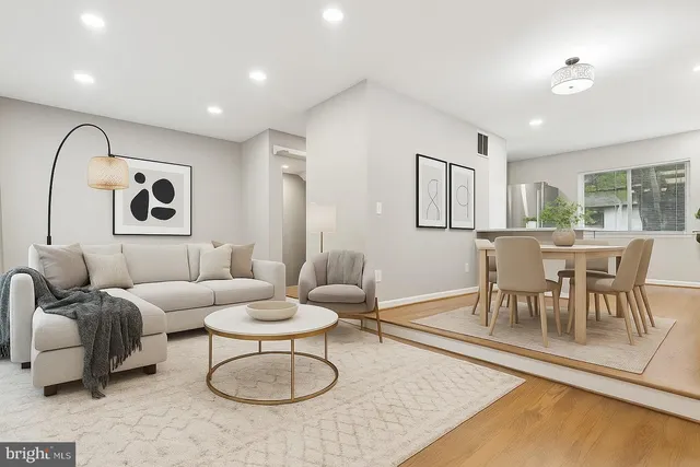 a view of a living room and a kitchen with a sink