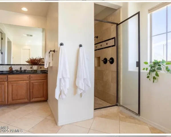 a bathroom with a shower and a sink