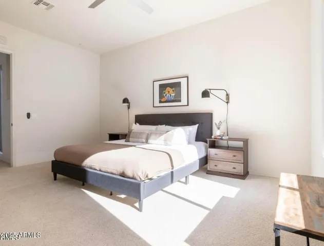 a bedroom with a bed and a lamp