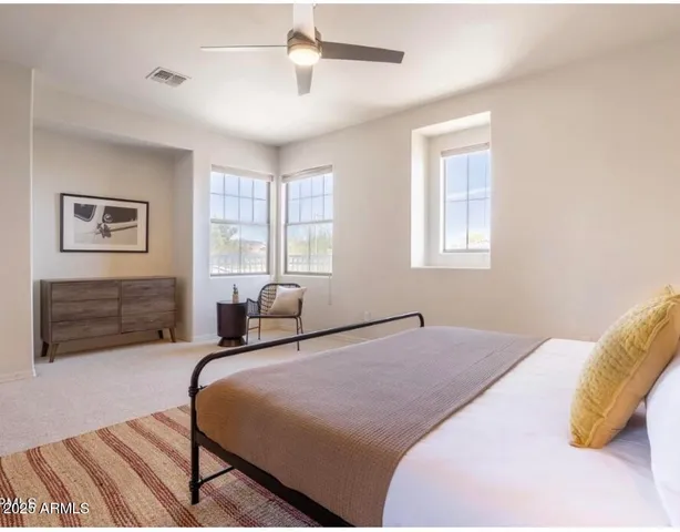 a bedroom with a bed a couch and dresser