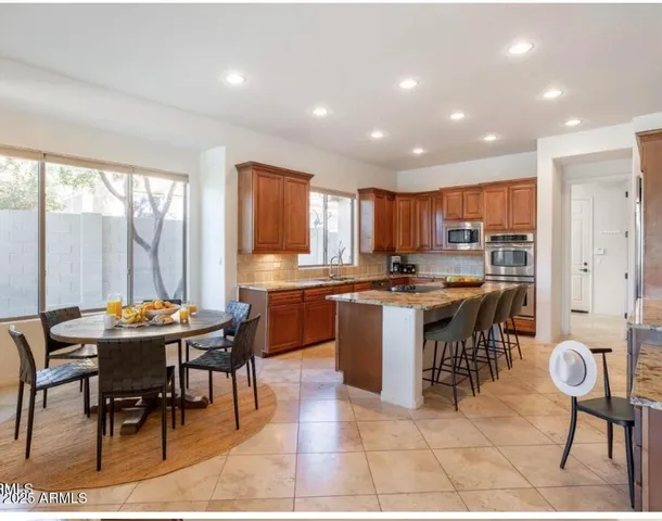 a kitchen with a table and chairs in it