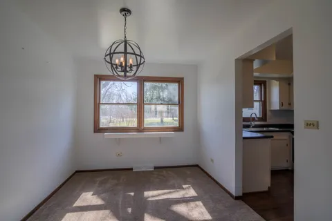 a view of a chandelier and a stove in a room