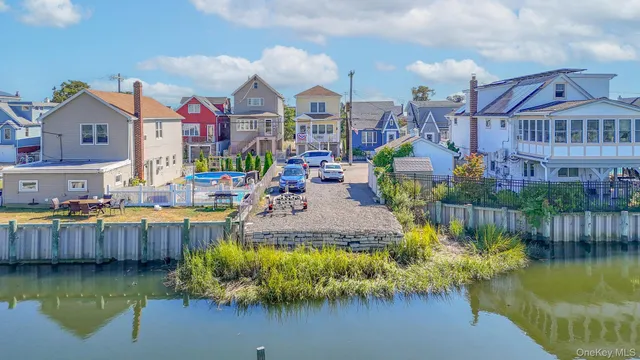 a swimming pool view with a seating space and a swimming pool