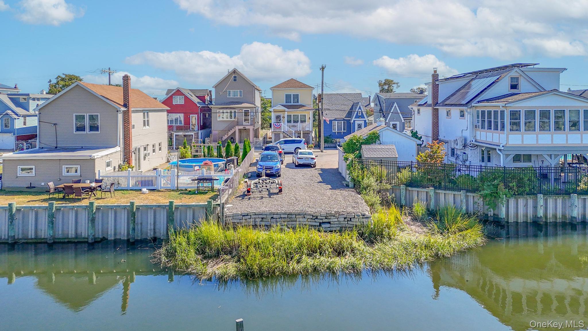 21 West 18th Road Queens, NY 11693 - Photo 2 of 3 a swimming pool view with a seating space and a swimming pool
