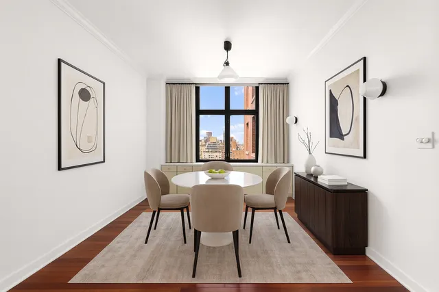 a view of a dining room with furniture window and wooden floor