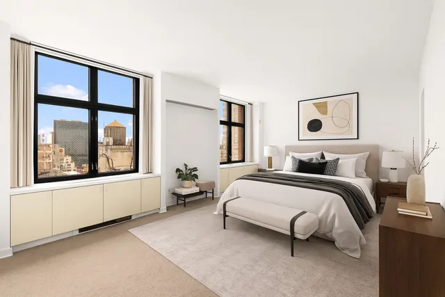 a spacious bedroom with a bed and a large window