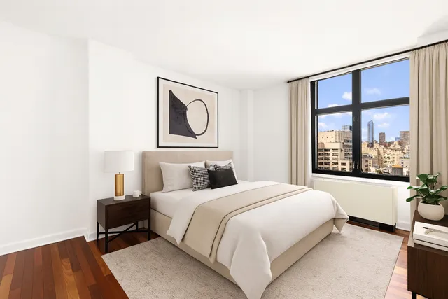 a bedroom with a bed and a large window