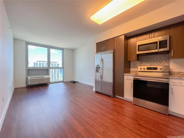 a view of a kitchen with a stove cabinets and wooden floor
