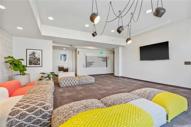 a bedroom with a bed dresser and flat screen tv