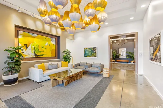 a living room with furniture a rug and a chandelier