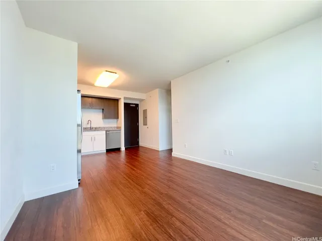 a view of a kitchen with wooden floor and a sink