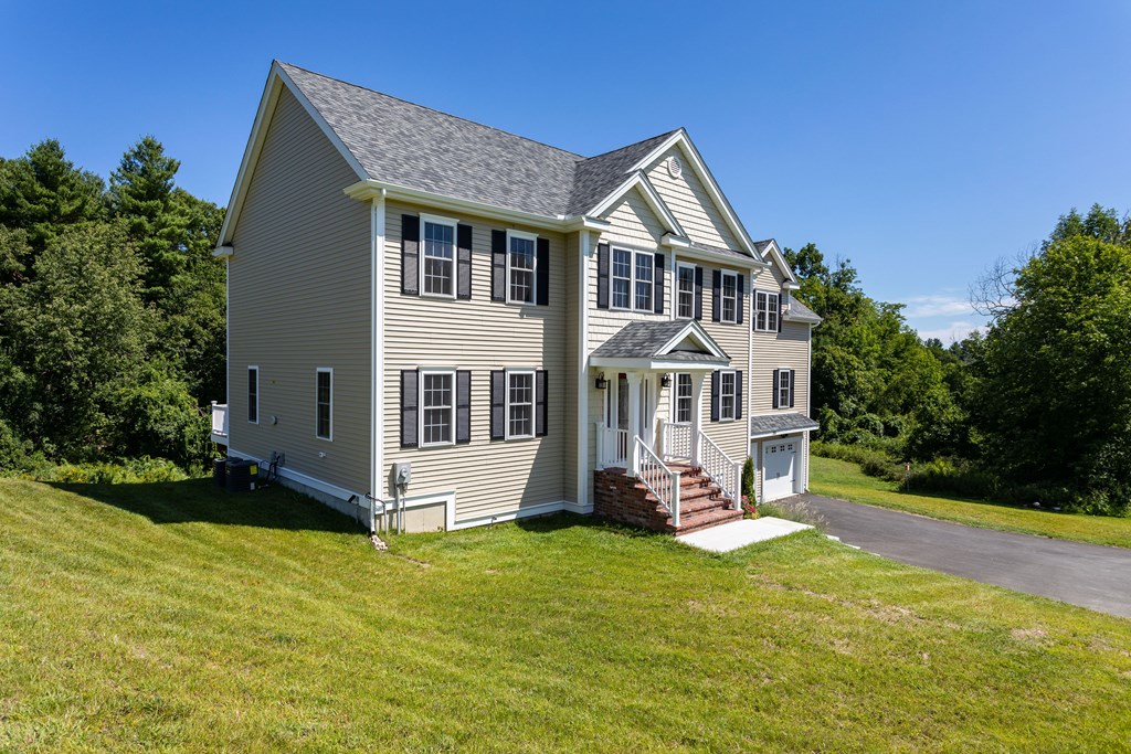 285 Putnam Hill Road Sutton, MA 01590 - Photo 1 of 6 a front view of a house with a yard