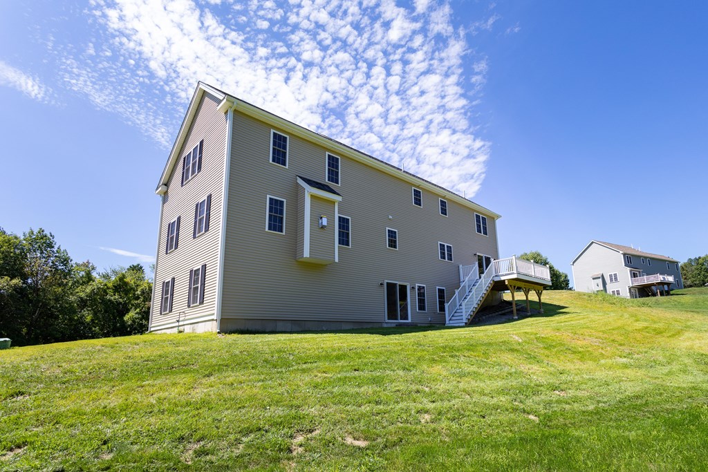 285 Putnam Hill Road Sutton, MA 01590 - Photo 5 of 6 a front view of house with yard and trees in the background