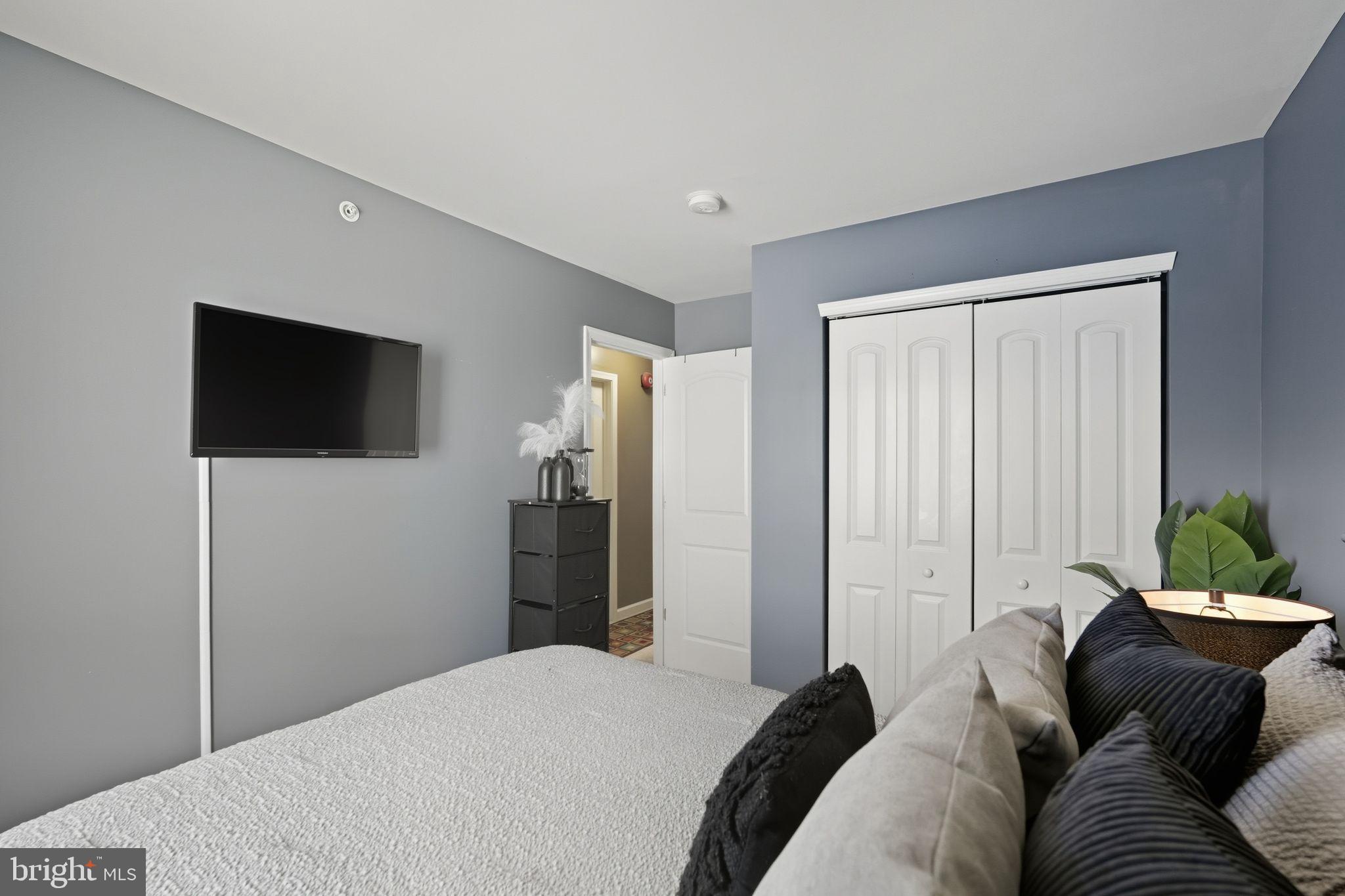 153 Mercer Court Fairless Hills, PA 19030 - Photo 19 of 29 a living room with a bed furniture and a flat screen tv
