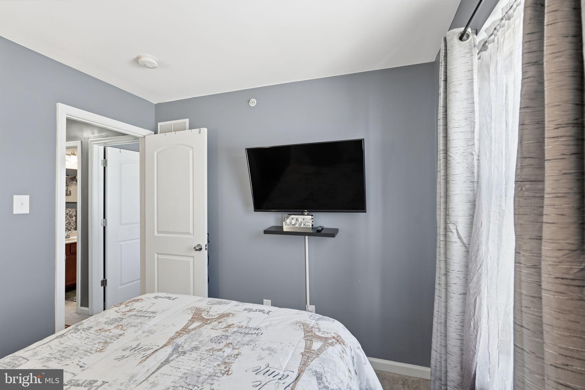 153 Mercer Court Fairless Hills, PA 19030 - Photo 22 of 29 a bedroom with a bed and a flat screen tv