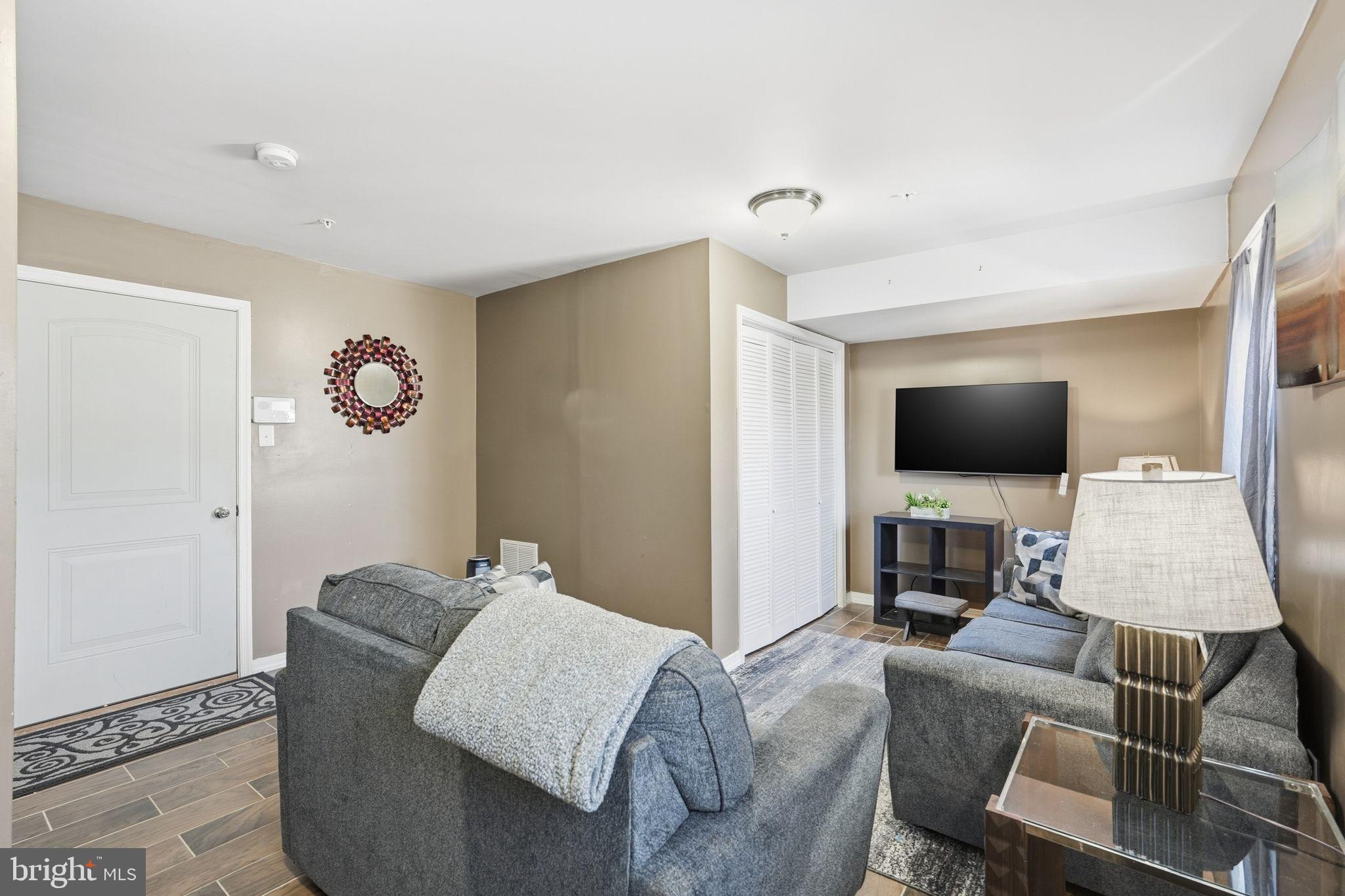 153 Mercer Court Fairless Hills, PA 19030 - Photo 24 of 29 a living room with furniture and a flat screen tv