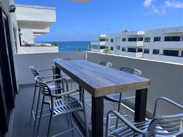 a dinning table and chairs in a balcony