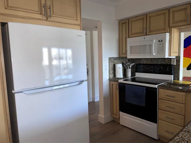 a kitchen with a stove and a refrigerator