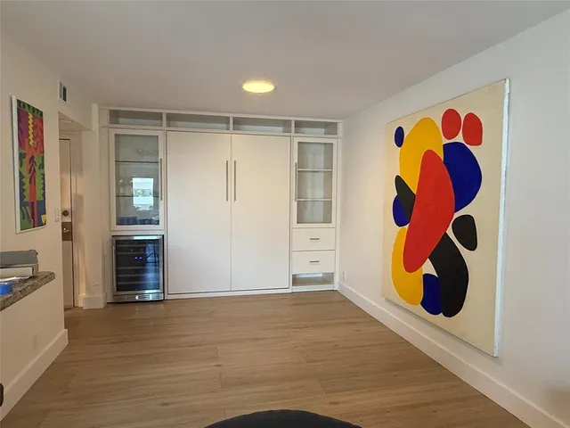 a view of an empty room with wooden floor