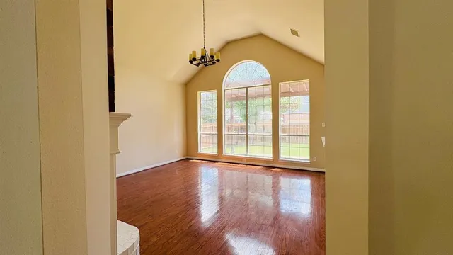 a view of a hallway with wooden floor and a fireplace