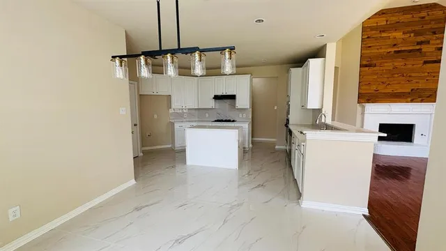 a kitchen with white cabinets and white appliances