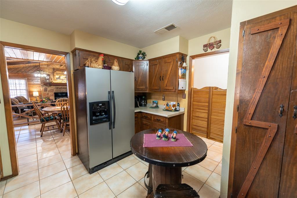 419 County Road Southeast Scroggins, TX 75480 - Photo 12 of 30 a room with a refrigerator and washer