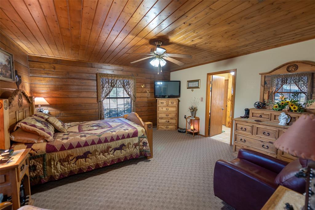 419 County Road Southeast Scroggins, TX 75480 - Photo 15 of 30 a bedroom with furniture and a chandelier