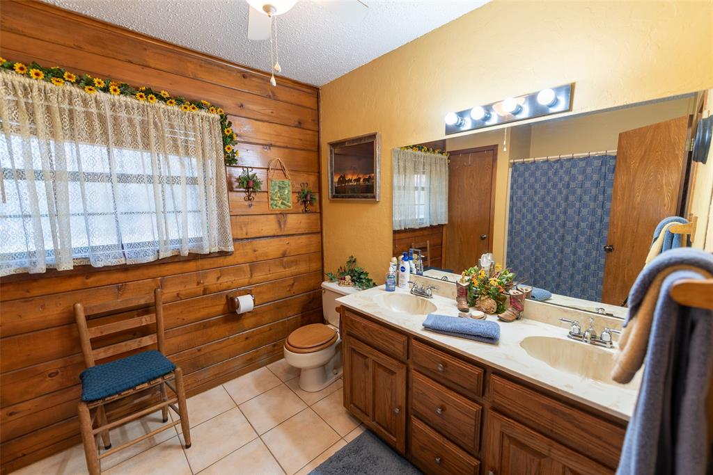 419 County Road Southeast Scroggins, TX 75480 - Photo 21 of 30 a bathroom with a sink mirror and a bathtub