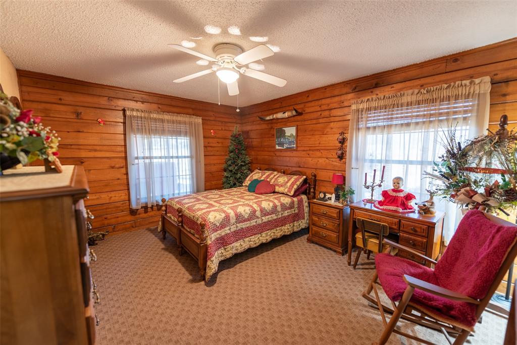 419 County Road Southeast Scroggins, TX 75480 - Photo 23 of 30 a bedroom with a bed and a chandelier