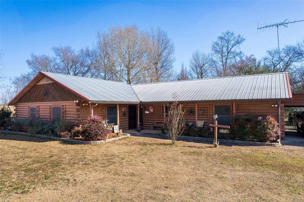 419 County Road Southeast Scroggins, TX 75480 - Photo 3 of 30 a front view of a house with a yard and garage