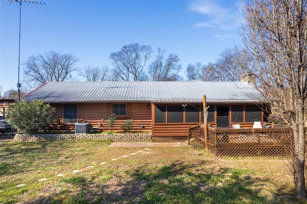 419 County Road Southeast Scroggins, TX 75480 - Photo 4 of 30 a front view of house with yard and trees in the background