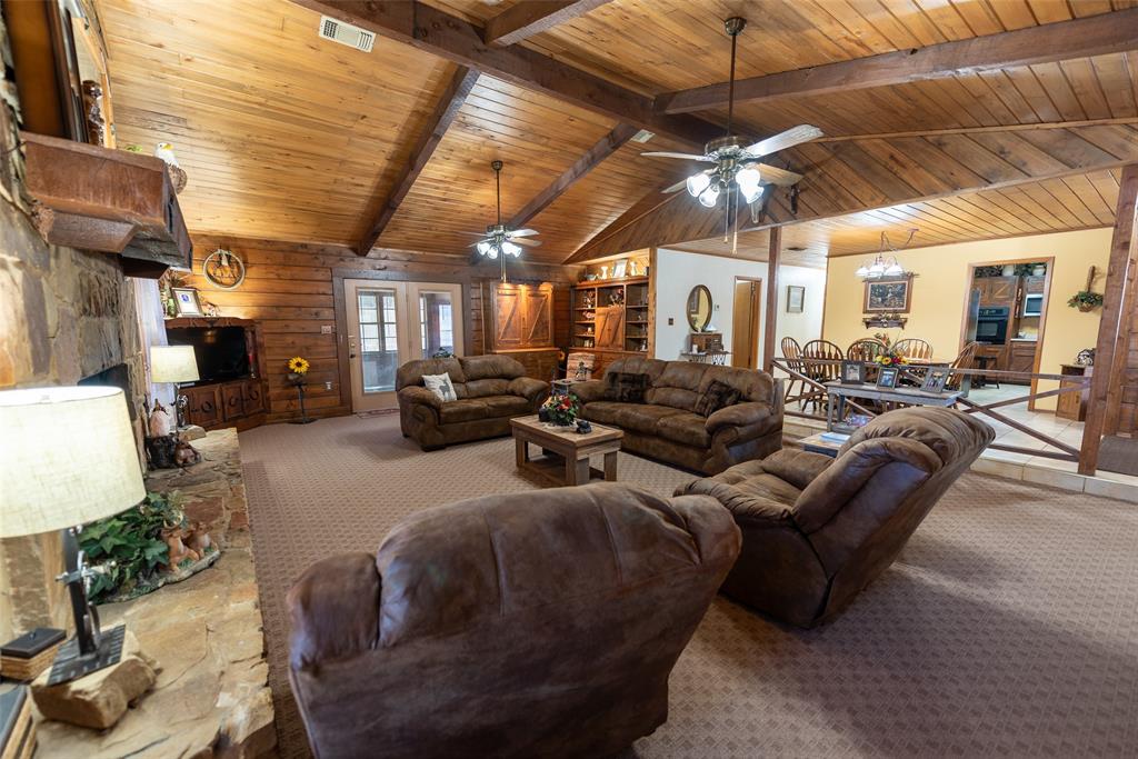 419 County Road Southeast Scroggins, TX 75480 - Photo 6 of 30 a living room with furniture and a chandelier