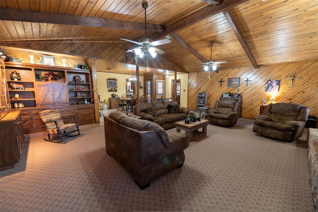 419 County Road Southeast Scroggins, TX 75480 - Photo 7 of 30 a living room with furniture and a chandelier