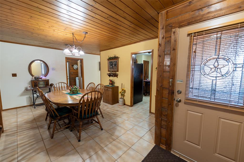 419 County Road Southeast Scroggins, TX 75480 - Photo 10 of 30 a view of a dining room with furniture and chandelier