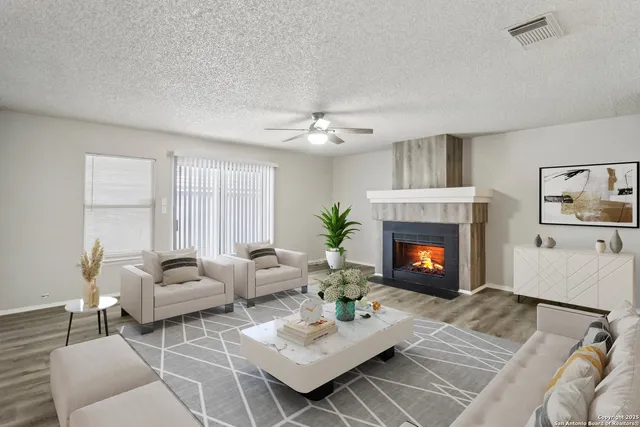 a living room with furniture and a fireplace
