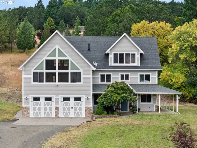 a view of a house with yard and sitting area
