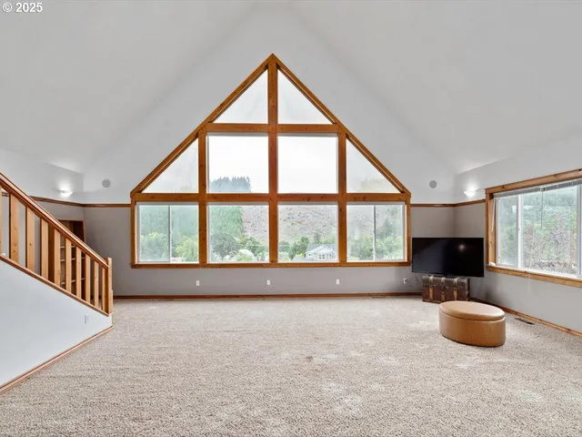 an empty room with furniture and windows