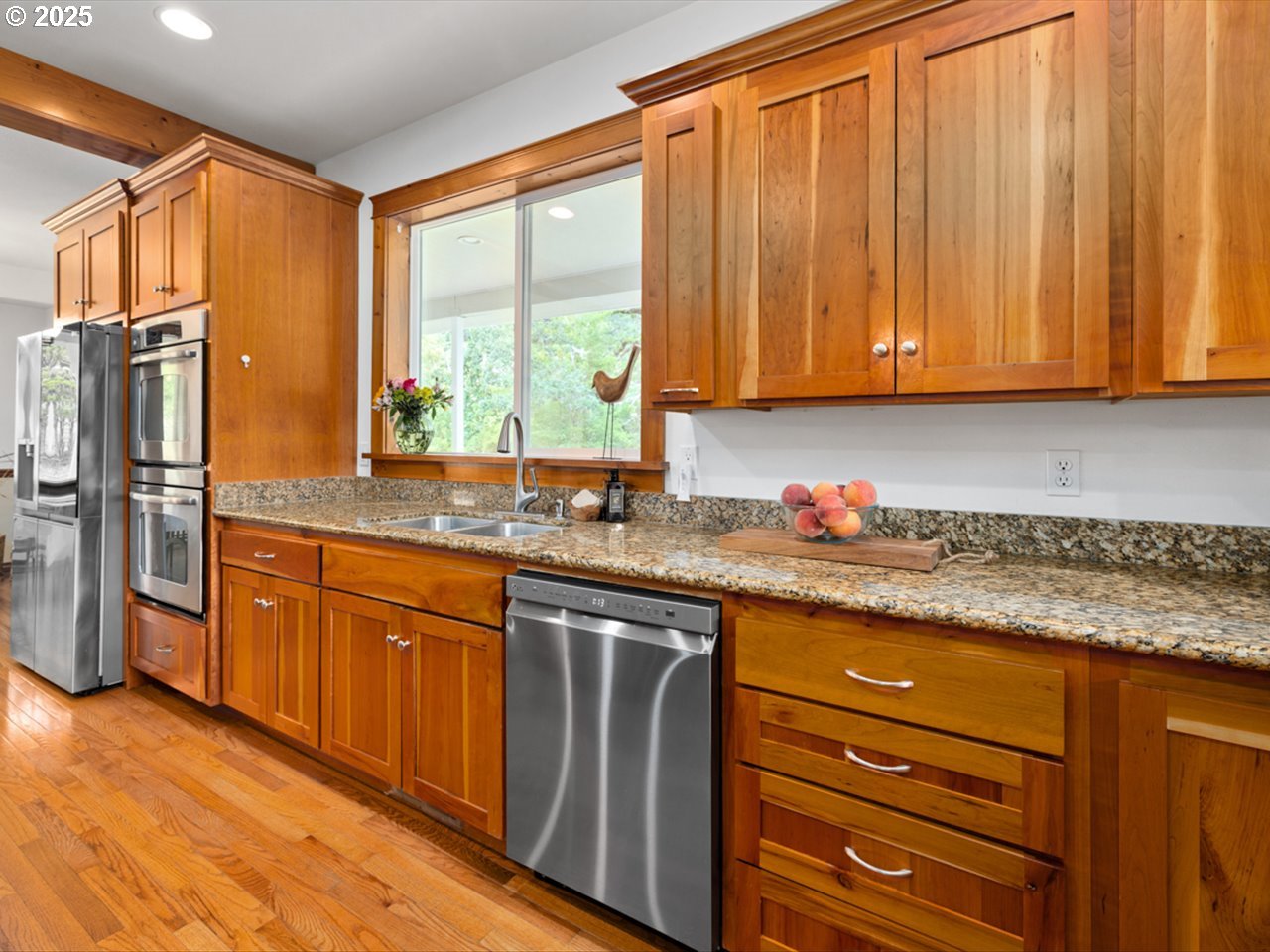 33678 Marys River Estates Road Philomath, OR 97370 - Photo 25 of 48 a kitchen with granite countertop wooden cabinets stainless steel appliances a sink and a window